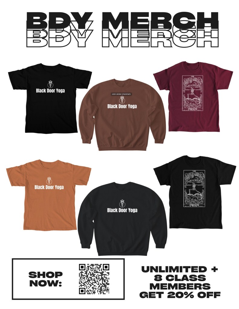 Merchandise display featuring apparel with 'Black Door Yoga' branding including t-shirts and sweatshirts.